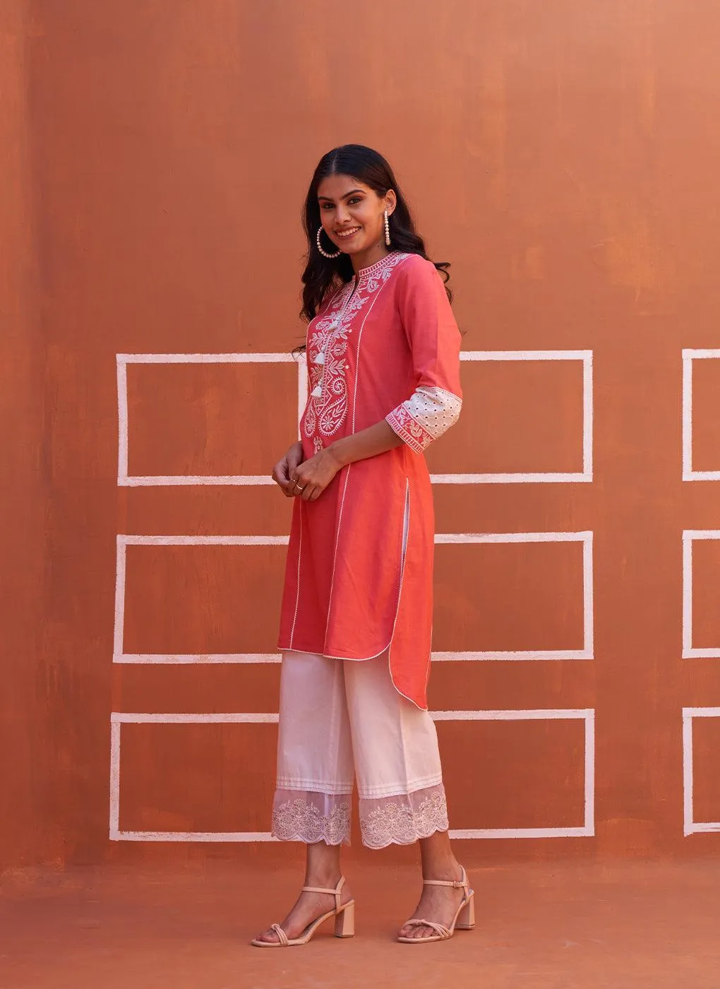 Peach Embroidered Kurta with Asymmetric Hem and Schiffili Detailing on the Sleeves